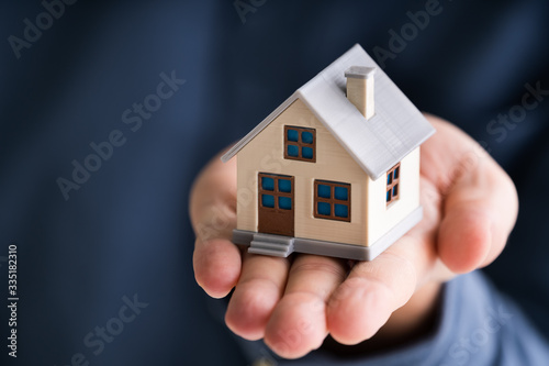 Businessman Holding House Model