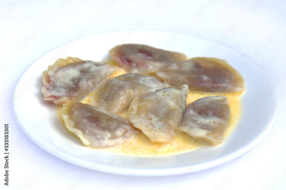 Boiled Dumplings with Cherry in Butter, dishes of Russian national cuisine Boiled Dumplings with Cherry in Butter, dishes of Russian national cuisine