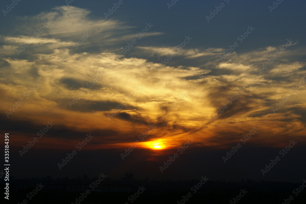 circle of the sun inside the clouds of the evening sunset circle of the sun inside the clouds of the evening sunset
