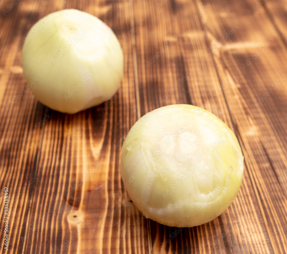 Fresh peeled onions on a wooden background. Fresh peeled onions on a wooden background.