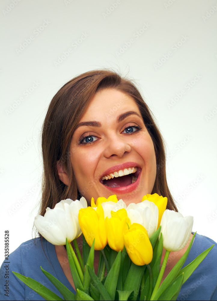 portrait of smiling woman holding tulips flowers in front of face portrait of smiling woman holding tulips flowers in front of face