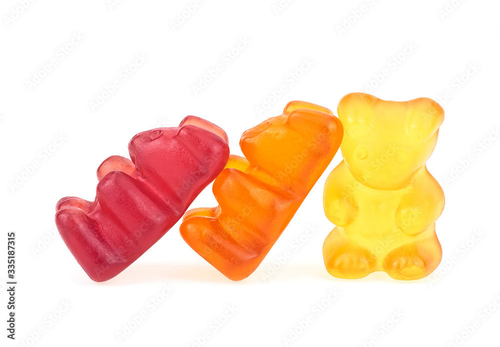 Three gummy bears on a white background. Colorful gel bear dessert. Three gummy bears on a white background. Colorful gel bear dessert.
