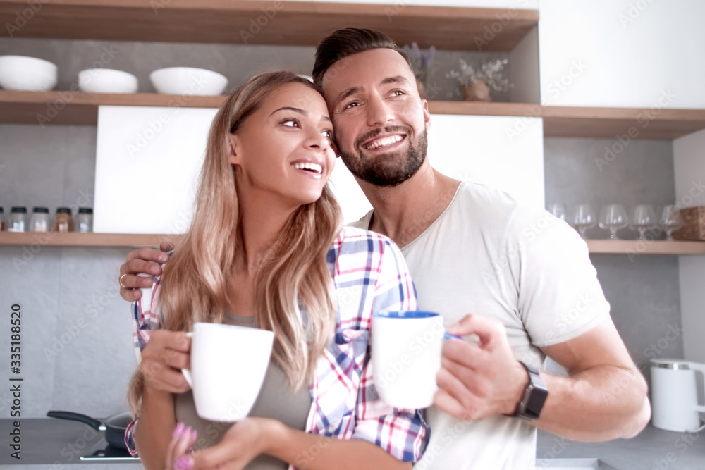 young couple in love in the kitchen in a good morning young couple in love in the kitchen in a good morning
