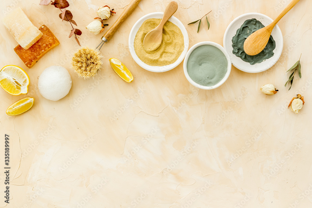 Clay mask in bowl for facial spa on beige background top view copy space