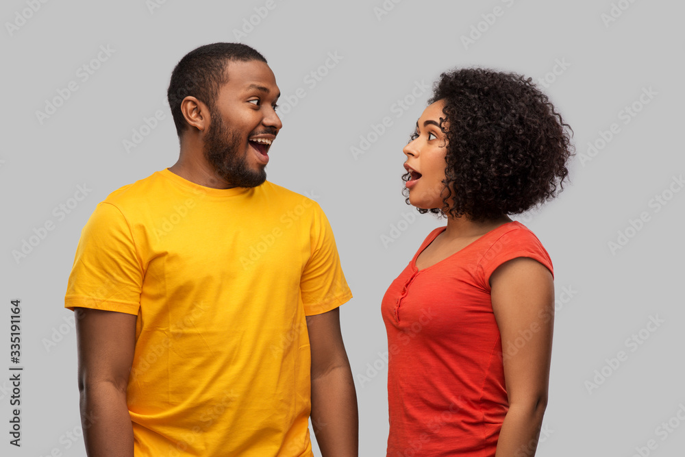 relationships and people concept - happy excited african american couple over grey background relationships and people concept - happy excited african american couple over grey background