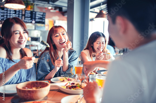 happy young group dining  at restaurant