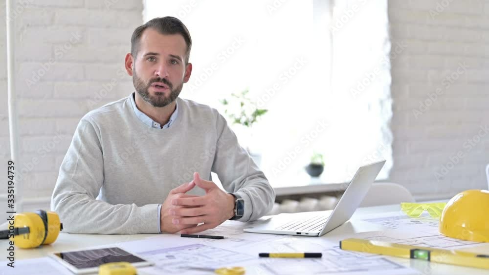 Handsome Young Architect doing Video Chat in Office Handsome Young Architect doing Video Chat in Office