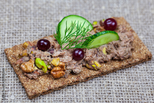 Dietary nutrition. Quail paste with peanuts on crisp bread. Fresh goose paste, photo