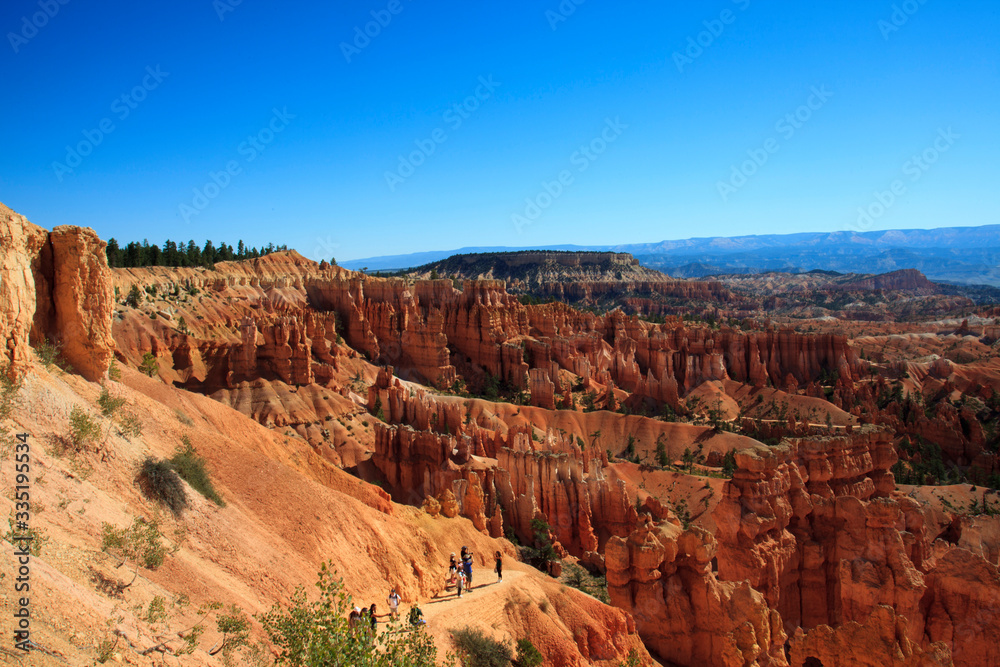 Utah / USA - August 22, 2015: Tourists walking in a pathway near Hoodoo and rock formation in Bryce Canyon National Park, Utah, USA