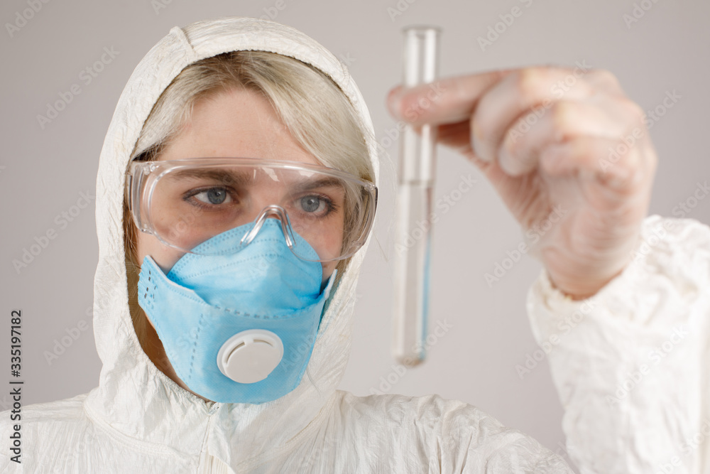 A girl in a protective suit and a respirator to protect health from viral, epidemic and infectious diseases. New Covid-19. Corona virus pandemic concept. Stop the virus. A girl in a protective suit and a respirator to protect health from viral, epidemic and infectious diseases. New Covid-19. Corona virus pandemic concept. Stop the virus.