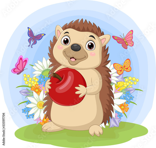 Cartoon hedgehog holding apple in the grass