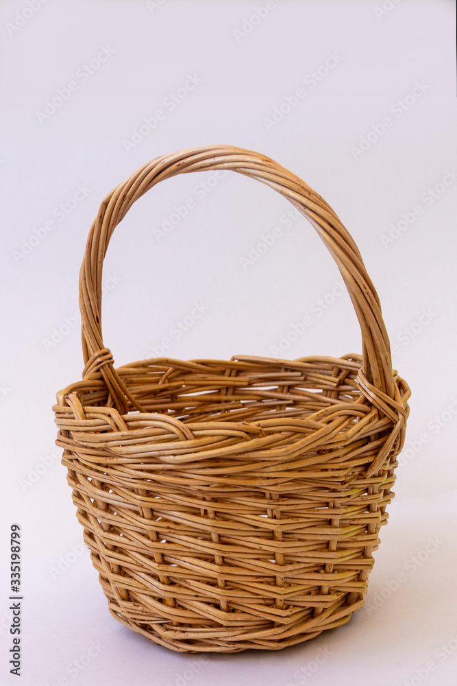 Wicker basket of vines with a handle on a white background Wicker basket of vines with a handle on a white background