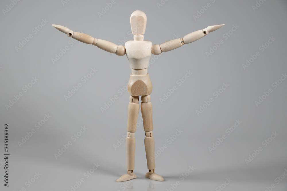 Wooden Mannequin on gray background Wooden Mannequin on gray background