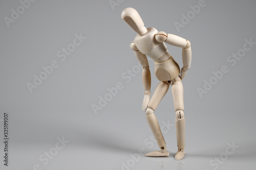 Wooden Mannequin on gray background