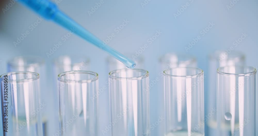 Working in Laboratory - Scientist Using Pipette in Lab. Working in Laboratory - Scientist Using Pipette in Lab.