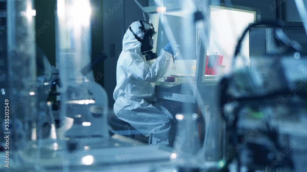 Researcher in protective suit creates a vaccine. Researcher in protective suit creates a vaccine.
