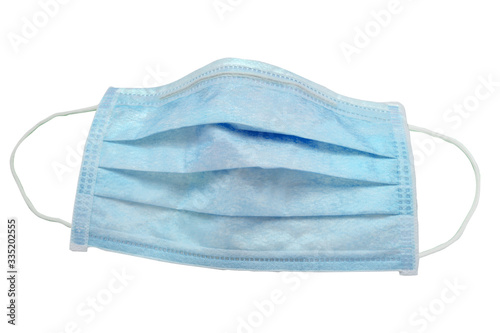 Used green 3 ply disposable surgical mask isolated on gray background, with clipping path