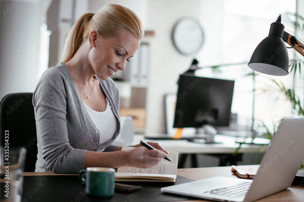 Young woman at work. Beautiful businesswoman working in office. Young woman at work. Beautiful businesswoman working in office.