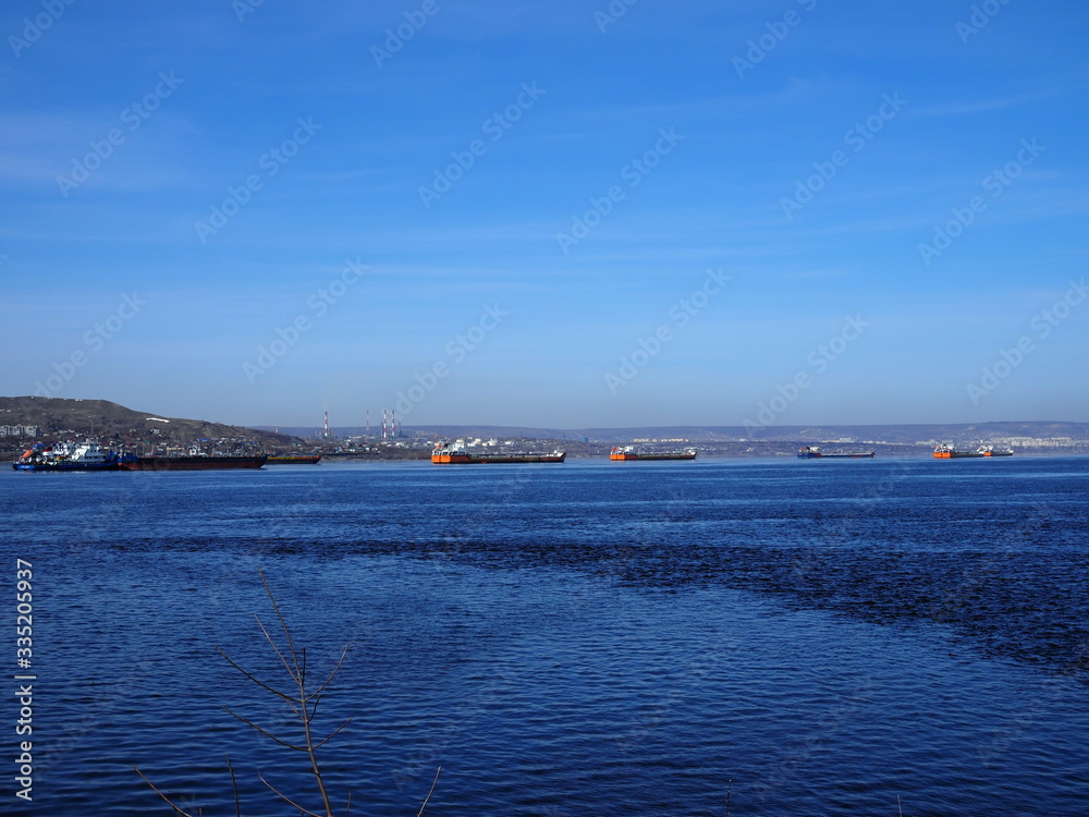 Cargo ships stand in the roadstead on the Volga River near Saratov
