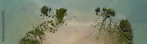 Top view of a piece of beach that runs into the water in Northland, New Zealand. photo