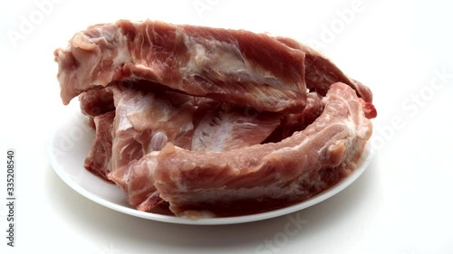 Raw Pork Ribs On White Plate and White Background. 360 rotation