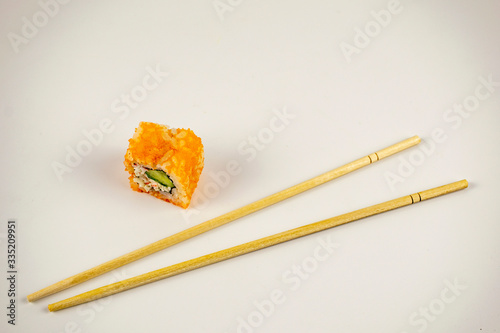 Natural Japanese food sushi with sticks and raw fish with rice.