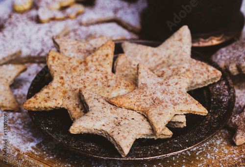 Star shaped christmas cookies decorated sugar and cocoa powder.