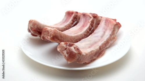 Raw Pork Ribs On White Plate and White Background. 360 rotation