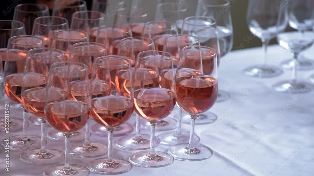 Glasses with pink and white wine on a banquet table. Wedding buffet.