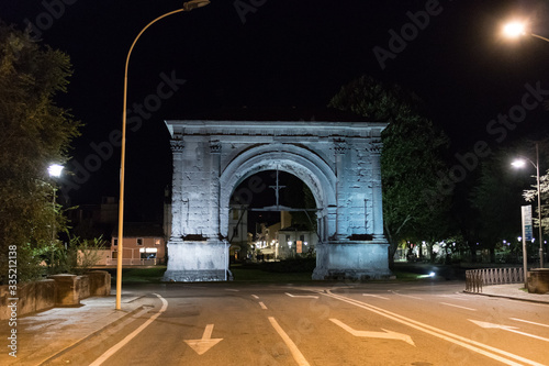 Roman Arch of Augustus at night. Ancient gate of the city of Aosta. Aosta Valley, Italy