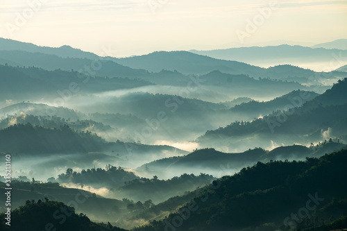 Fotografie Beautiful Landscape of mountain layer in morning sun ray and winter fog at Doi H