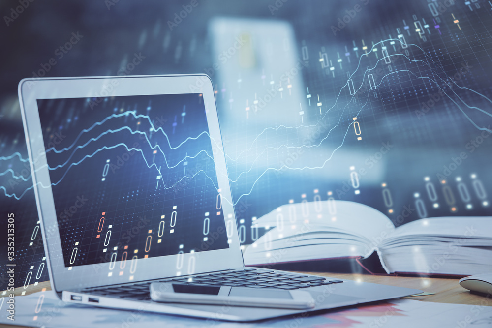 Forex graph hologram on table with computer background. Double exposure. Concept of financial markets. Forex graph hologram on table with computer background. Double exposure. Concept of financial markets.