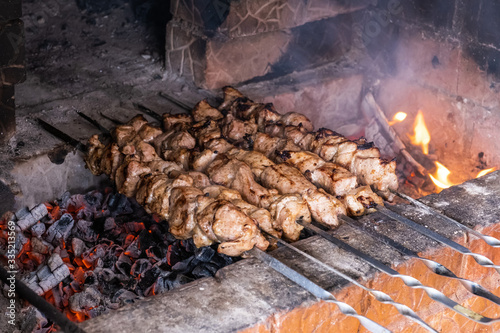 Kebabs on skewers are cooked on hot coals in the oven