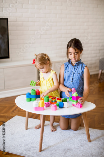 Two little girls play with ...