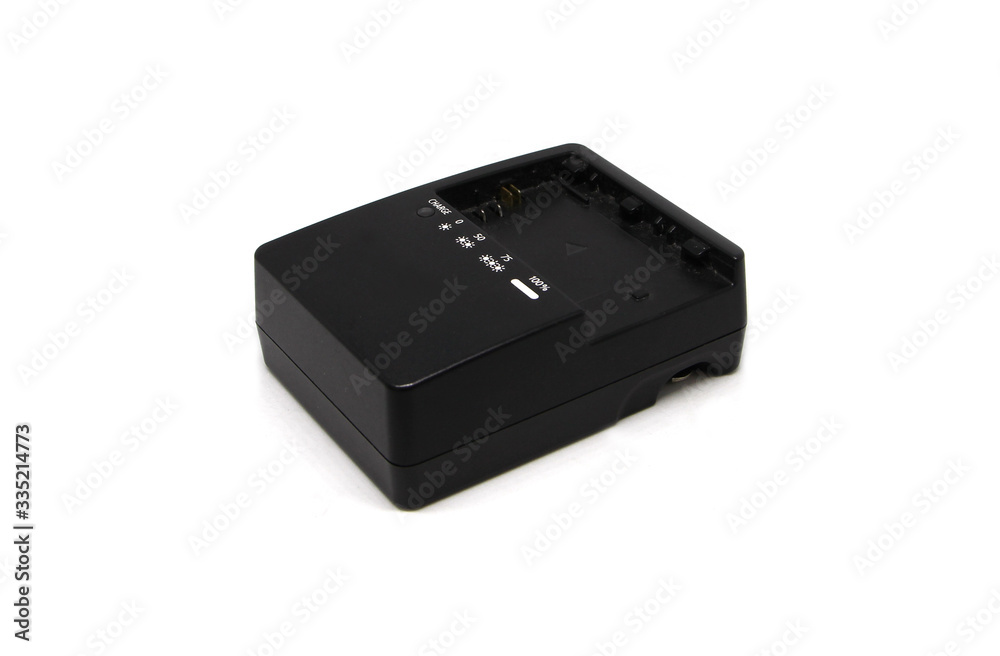 At the camera battery charger isolated on white background At the camera battery charger isolated on white background