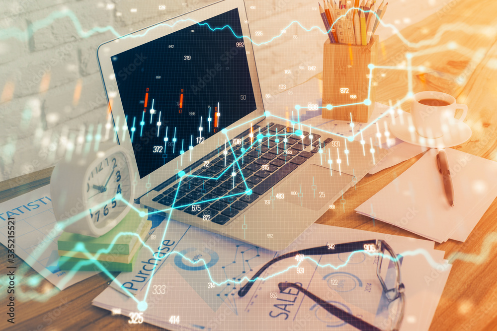 Financial graph colorful drawing and table with computer on background. Double exposure. Concept of international markets.