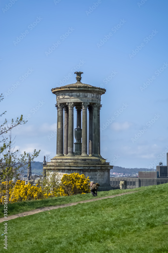 Naklejka premium View of Dugald Stewart Monument with vegetation around and a path , in Edinburgh