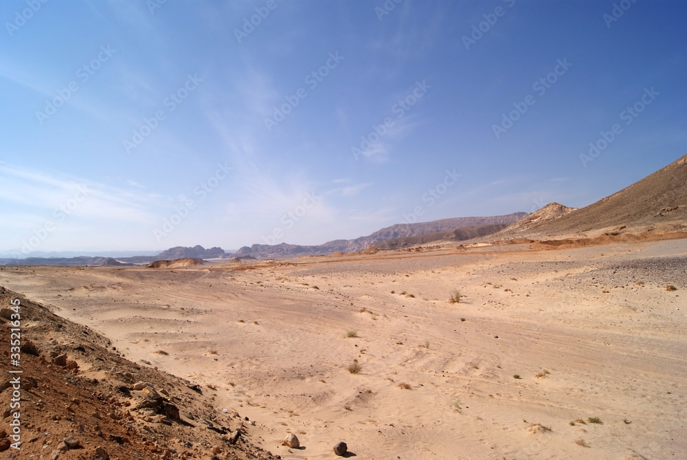 Beautiful panorama of the Sinai Desert. Mountains and sands of different shades. Clear blue sky
