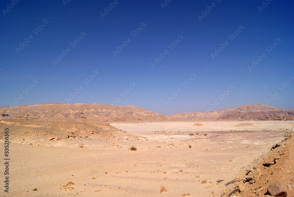 Beautiful panorama of the Sinai Desert. Mountains and sands of different shades. Clear blue sky