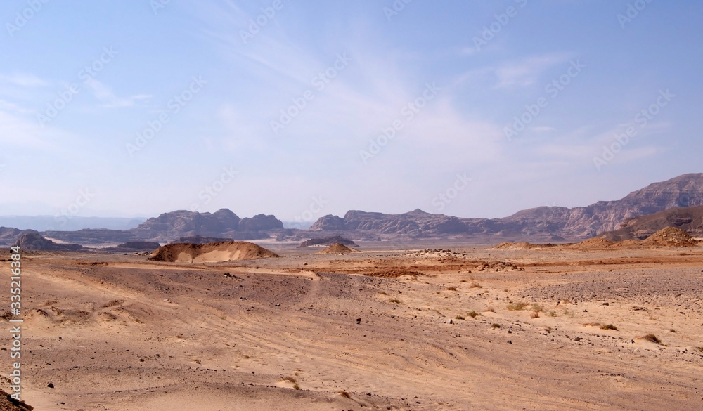 Beautiful panorama of the Sinai Desert. Mountains and sands of different shades. Clear blue sky