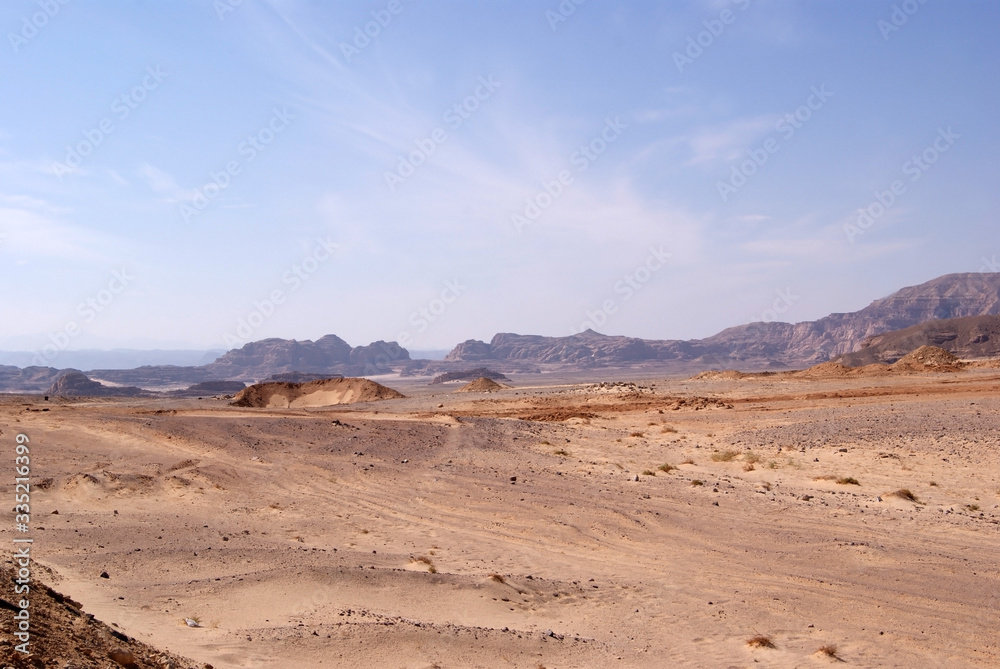 Beautiful panorama of the Sinai Desert. Mountains and sands of different shades. Clear blue sky