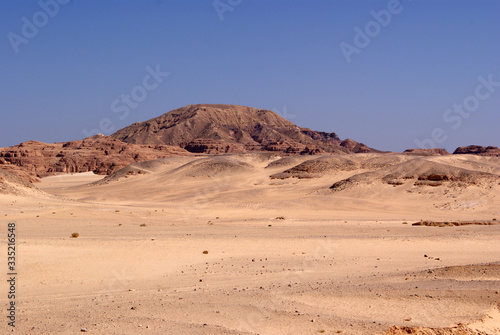 Beautiful panorama of the Sinai Desert. Mountains and sands of different shades. Clear blue sky