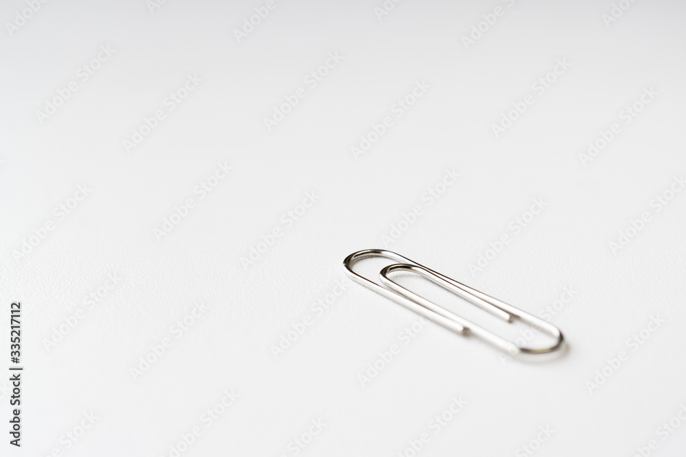 Silver paper clip isolated on white background Silver paper clip isolated on white background