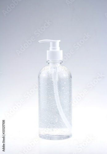  Alcohol White gel. White bottle dispenser pump with tube transparent bubble liquid filled container from front top angle isolated on white background.
