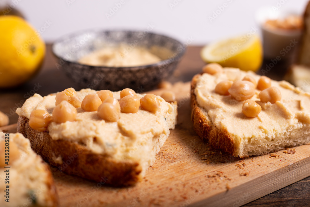 Homemade bruschetta with hummus and boiled chickpeas. Delicious and healthy snack or appetizer.