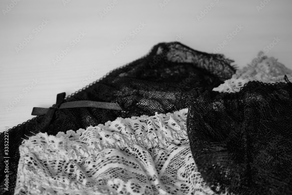 set of women's lace panties on a white background. Women's underwear on the table. black-white set of women's lace panties on a white background. Women's underwear on the table. black-white