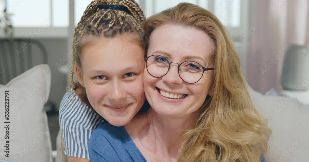 Happy positive mother and adult daughter smiling looking to camera. Strong connection between family generations. Trustful relationships between parents and kids