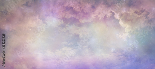 Heavens above celestial concept background banner - beautiful blue pink purple green lilac light filled heavenly ethereal cloud scape depicting the heavens above 
 photo