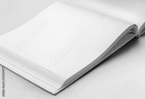 Fototapeta Naklejka Na Ścianę i Meble -  Mockup of a white blank page of an open landscape orientation book, with realistic shadows, for design presentation.
