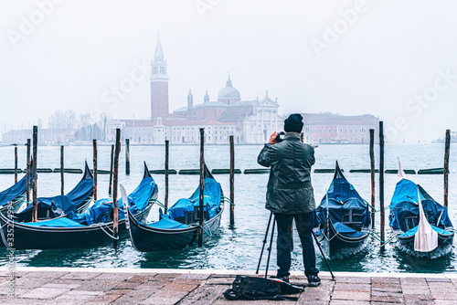 tourist taking photo of gondolas on san marco,  venice, italy © Hein van Tonder